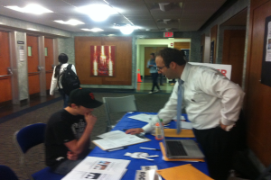 Dr. Klein explaining how to register to Mercy College Sophomore Rob Murphy.