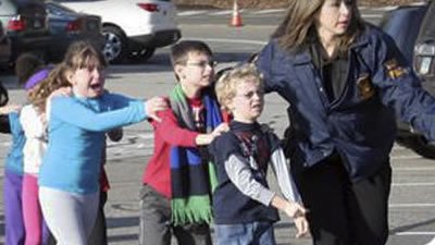 Scared children wait single file earlier today.