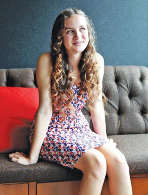 NICE SHOT OF MAUDIE APATOW SITTING ON COUCH THINKING. 