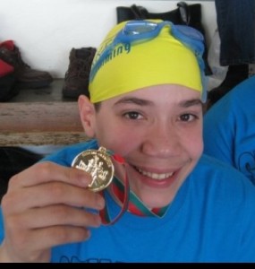 Marrero posing with one out of the 20 medals he has won in competition