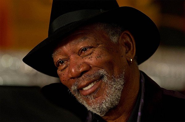 IS ACTOR MORGAN FREEMAN SMILING  OR TRYING TO REALLY PULL SOMETHING OFF AND BE A WISE GUY?