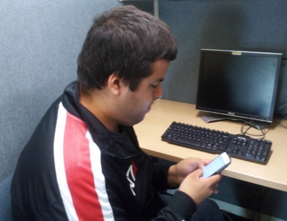 Student, Roberto Heriquez finds jobs through social media on his phone.