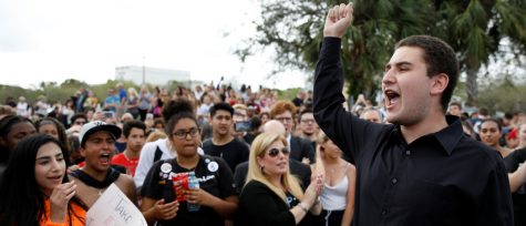 Student Alex Wind from Marjory Stoneman Douglas High School speaks to the crowd during a protest, following a mass shooting in Parkland, Florida, U.S., February 20, 2018. REUTERS/Carlos Garcia Rawlins - RC16D1A24280