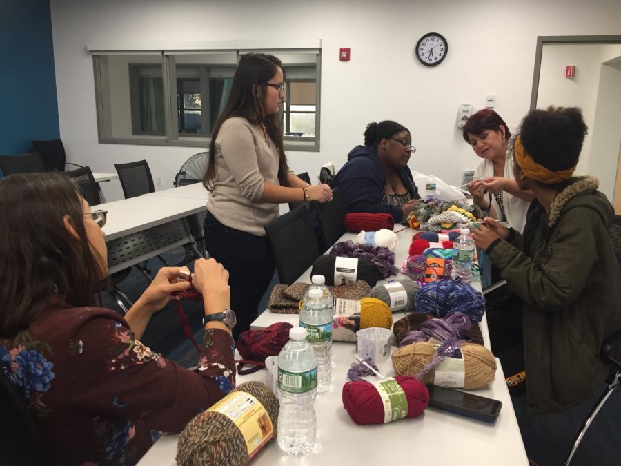 Mercy students and volunteers learn how to knit with the help of The Madristia Project founder Susana Luna and her daughter, Christal Luna. 