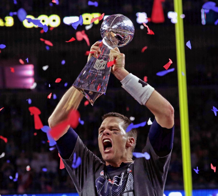 HOUSTON - FEBRUARY 5: New England Patriots quarterback Tom Brady (12) lets out a howl as he raises the Lombardi Trophy after winning Super Bowl LI in overtime.  The Atlanta Falcons play the New England Patriots in Super Bowl LI at NRG Stadium in Houston on Feb. 5, 2017.  (Photo by Barry Chin/The Boston Globe via Getty Images)